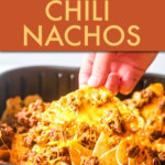 A HAND PULLING A NACHO CHIP OUT OF AN AIR FRYER