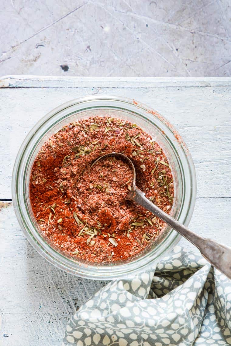 the finished blackened seasoning mix in a glass dish with a spoon