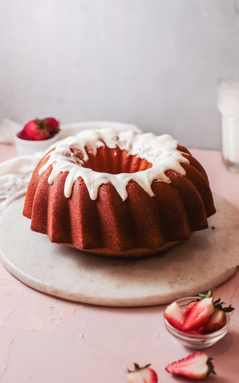 the completed cream cheese pound cake topped with glaze and ready to be served