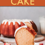 a slice of cake on a plate with a ring shaped cake in the background