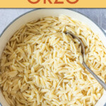 Overhead view of a bowl of orzo with a spoon in it