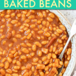 Close up of a bowl of baked beans with a spoon
