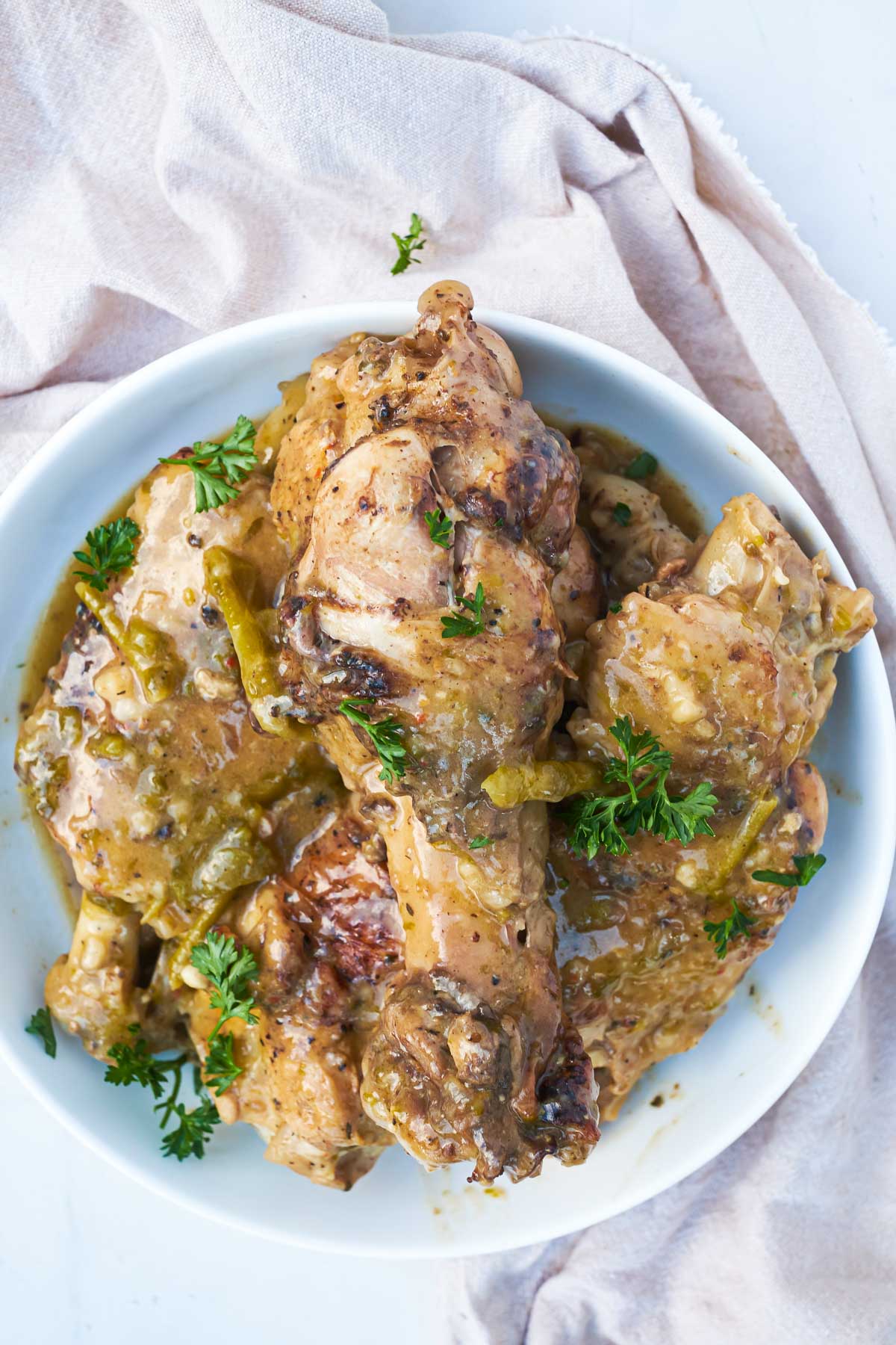 the completed instant pot turkey wings recipe in a serving dish on a table with pink cloth napkin