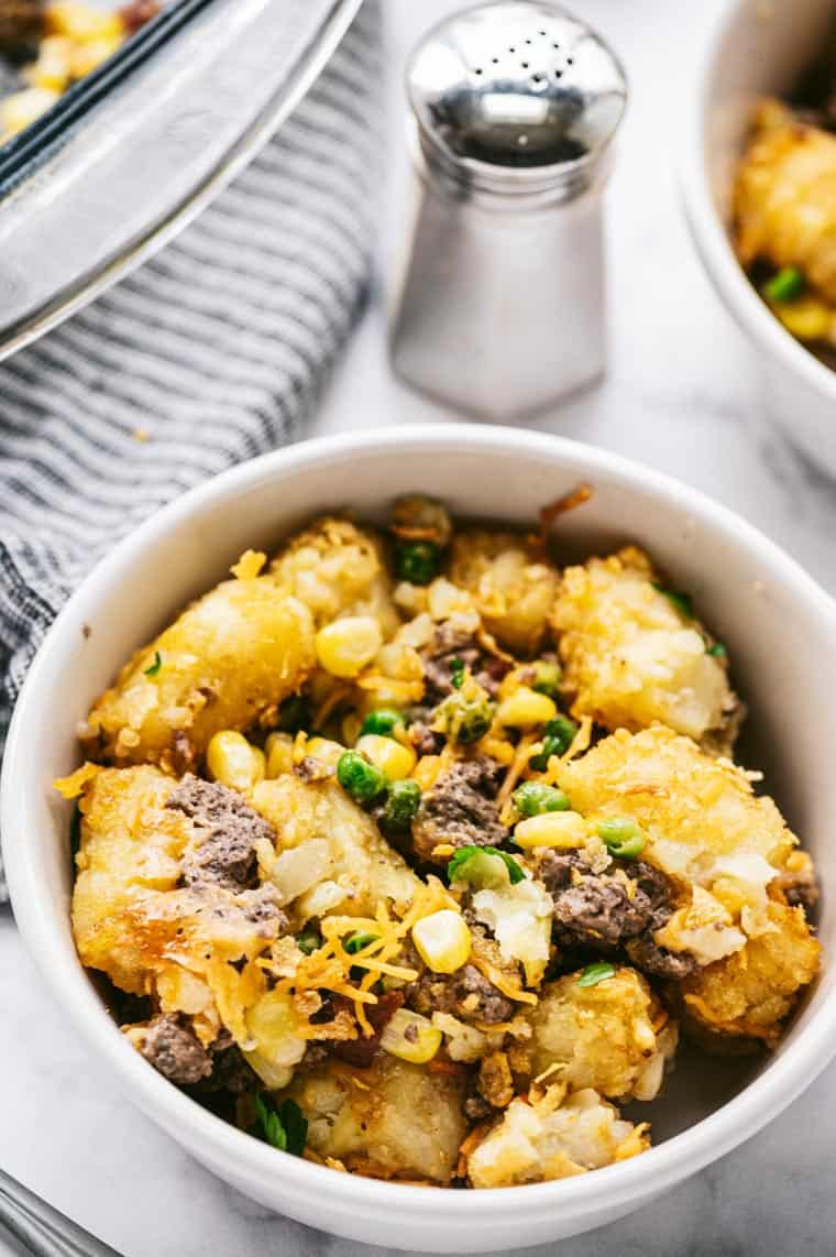 a serving of tater tot casserole in a white dish
